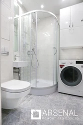 Photo Of A Bathroom With A Shower And A Washing Machine Without A Toilet