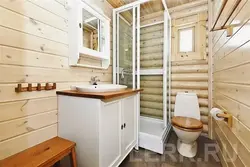 Interior of a bathroom with shower in a wooden house