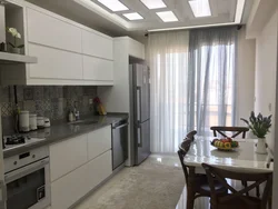 Interior of a rectangular kitchen with a balcony