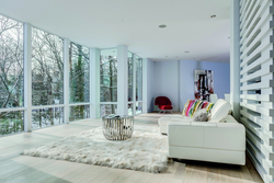 Living room design in a house with floor-to-ceiling windows