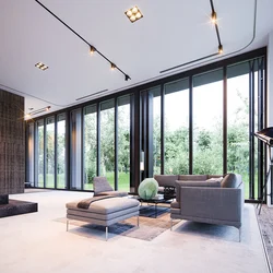Living room design in a house with floor-to-ceiling windows