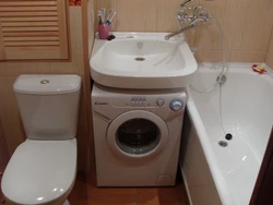 Photo of a small bathtub with a washing machine