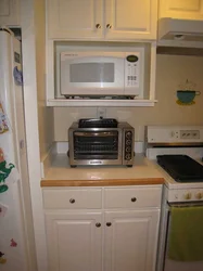 How to hang a microwave in the kitchen under the cabinets photo