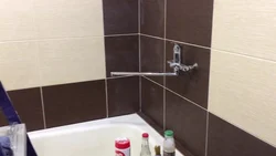 Photo of a bathtub with grout matching the color of the tiles