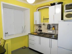 Photo of a small kitchen with a window and a column