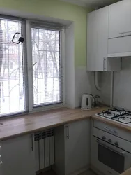 Photo of a small kitchen with a window and a column