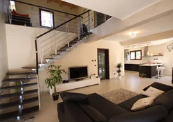 Design of a living room in a house with a photo staircase to the second floor