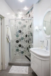 Shower in the bathroom with a tray made of small tiles photo
