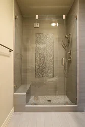 Shower in the bathroom with a tray made of small tiles photo