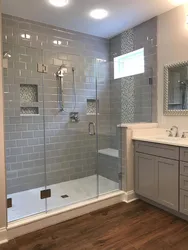 Shower in the bathroom with a tray made of small tiles photo