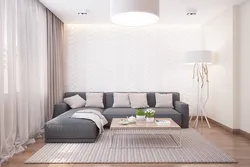Living room interior in an apartment in light colors and corner sofas