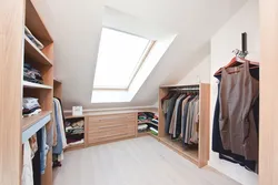 Dressing room in the attic with a sloping ceiling photo