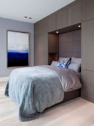 Bedroom with wardrobe at the head of the bed design