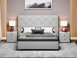 Bedroom design with a gray bed with a soft headboard