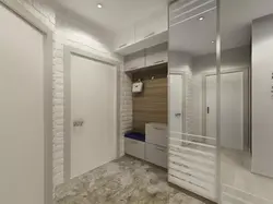 Design of a narrow hallway in an apartment with a wardrobe in a modern