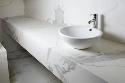 Countertop in the bathroom under the sink made of porcelain stoneware photo