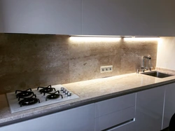 Kitchen with marble countertop and splashback photo