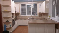 U-shaped kitchen design with a window in the middle