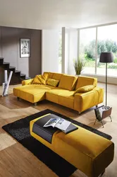 Photo of a living room with a mustard-colored sofa
