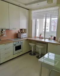 Design of a small kitchen with a window in an apartment