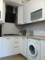 Corner kitchen design with refrigerator and washing machine photo