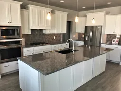White kitchen design with gray countertop photo