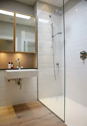 Bathroom interior with shower screen and washing machine
