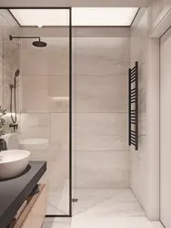 Bathroom interior with shower screen and washing machine
