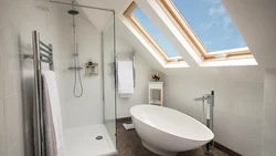 Bathroom design in the attic with a sloping ceiling