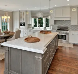 Kitchen with island in a country house design photo