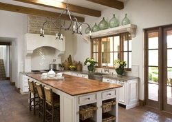 Kitchen with island in a country house design photo