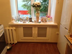 Cabinet in the window sill in the kitchen photo