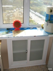 Cabinet in the window sill in the kitchen photo