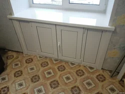 Cabinet in the window sill in the kitchen photo