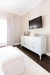 TV on the chest of drawers in the bedroom interior