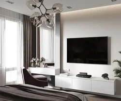 TV on the chest of drawers in the bedroom interior