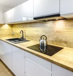 Bright Kitchen With Wooden Countertop And Apron In The Interior