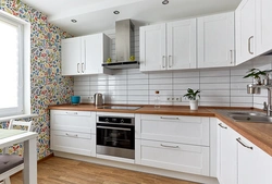 Bright kitchen with wooden countertop and apron in the interior