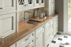 Bright kitchen with wooden countertop and apron in the interior