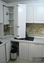 Kitchen design with a column and a refrigerator by the window