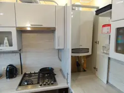 Kitchen Design With A Column And A Refrigerator By The Window