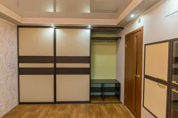 Built-in wardrobe along the entire wall in the hallway photo