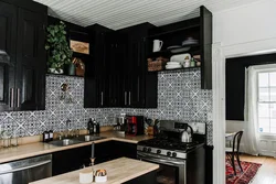 Photo of a kitchen with a black refrigerator photo