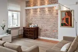Combination of wallpaper and brick in the living room interior