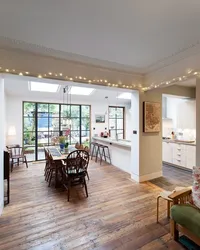 Design of a living room combined with a kitchen and access to the terrace