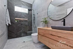 Photo of a bathtub made of concrete and wood tiles