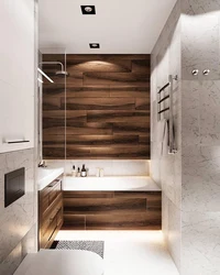 Photo of a bathtub made of concrete and wood tiles