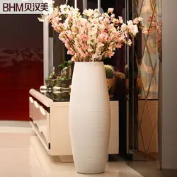 Floor vase with flowers in the interior of the living room