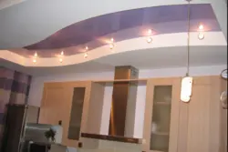Photo of two-level plasterboard ceilings in the kitchen with lighting