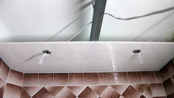 Step-by-step photo of a bathroom ceiling made of plastic panels